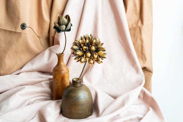Two wooden vase with dried flowers against draper. Modern creative still life.